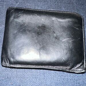 Tumi, black, leather bill-fold men’s wallet.